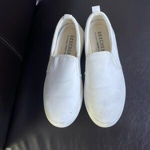 White SKETCHERS memory foam slip on sneakers ready for YOU.